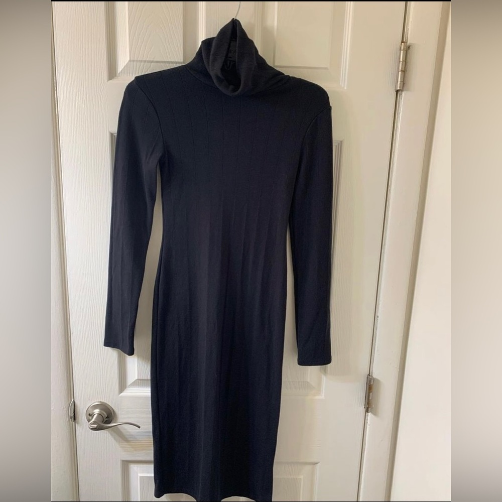 Black fitted turtleneck dress with small slit at the bottom